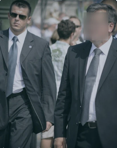 Executive Protection — plain-clothes officer with principal